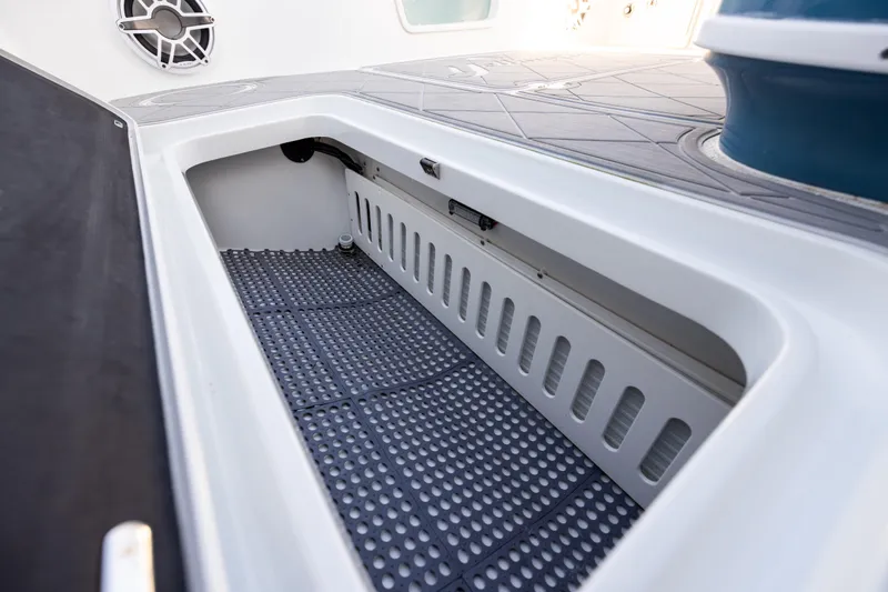 Slide: The Image of 2024 Yellowfin 42 Offshore boat storage compartment with non-slip flooring. - 70