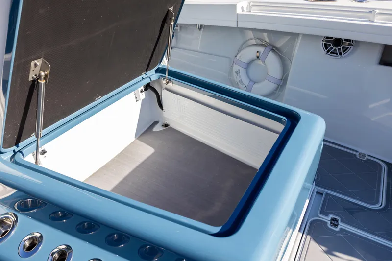 Slide: The Image of 2024 Yellowfin 42 Offshore boat with open storage compartment and life preserver. - 71