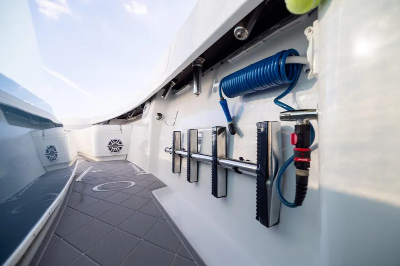 Slide: The Image of 2024 Yellowfin 42 Offshore boat deck with coiled hose and storage features. - 76