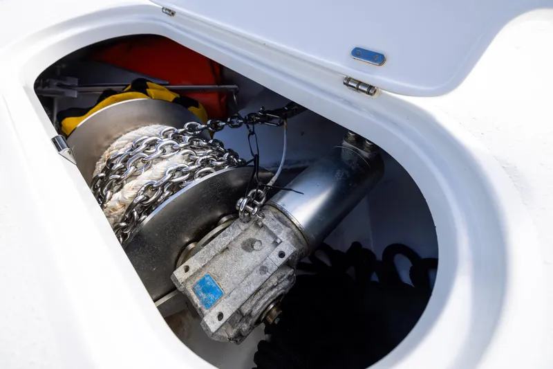 Slide: The Image of 2024 Yellowfin 42 Offshore boat anchor chain and winch in storage compartment. - 78