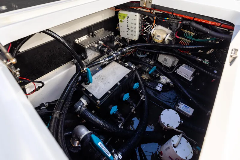 Slide: The Image of Engine compartment of 2024 Yellowfin 42 Offshore boat, showcasing complex wiring and components. - 79