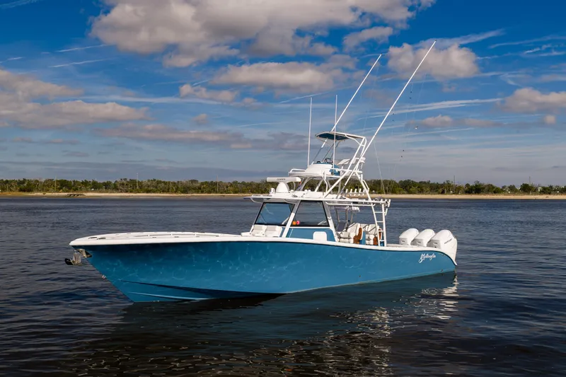 Slide: The Image of 2024 Yellowfin 42 Offshore boat on calm water under a blue sky. - 8