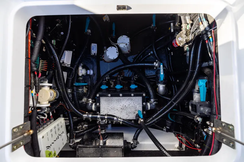 Slide: The Image of Engine compartment of 2024 Yellowfin 42 Offshore boat, showcasing complex wiring and components. - 80