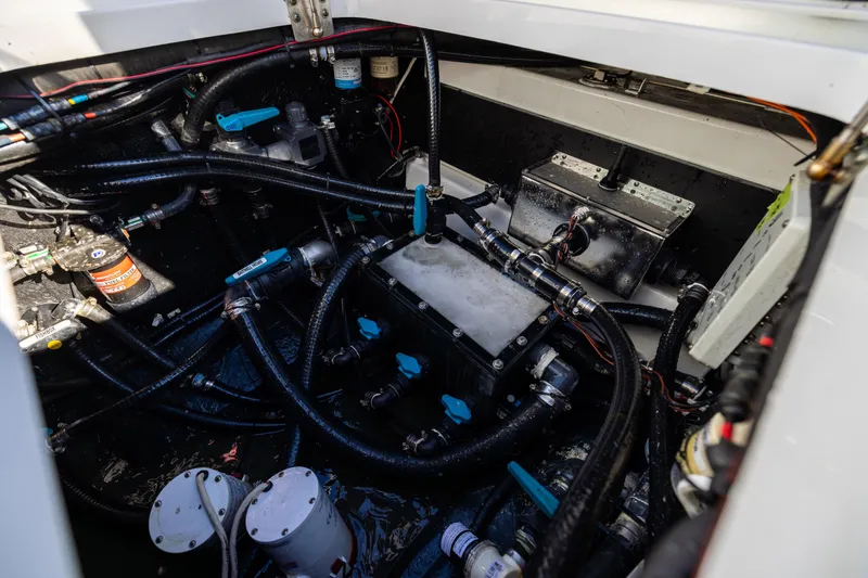 Slide: The Image of Engine compartment of 2024 Yellowfin 42 Offshore boat, showcasing complex wiring and components. - 81