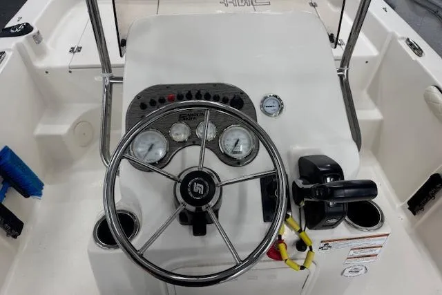 Slide: The Image of 2021 Carolina Skiff 17 LS boat console with steering wheel and gauges. - 3