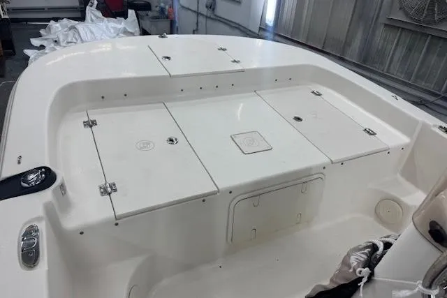 Slide: The Image of 2021 Carolina Skiff 17 LS boat interior with storage compartments in a workshop setting. - 5