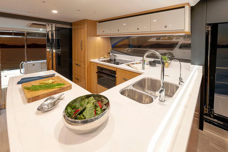 Slide: The Image of Manufacturer Provided Image: Luxurious kitchen interior of 2025 Riviera 585 SUV yacht with modern amenities. - 15