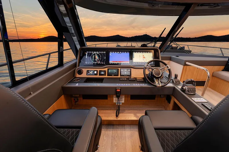 Slide: The Image of Manufacturer Provided Image: 2025 Riviera 585 SUV yacht interior with modern dashboard at sunset. - 17