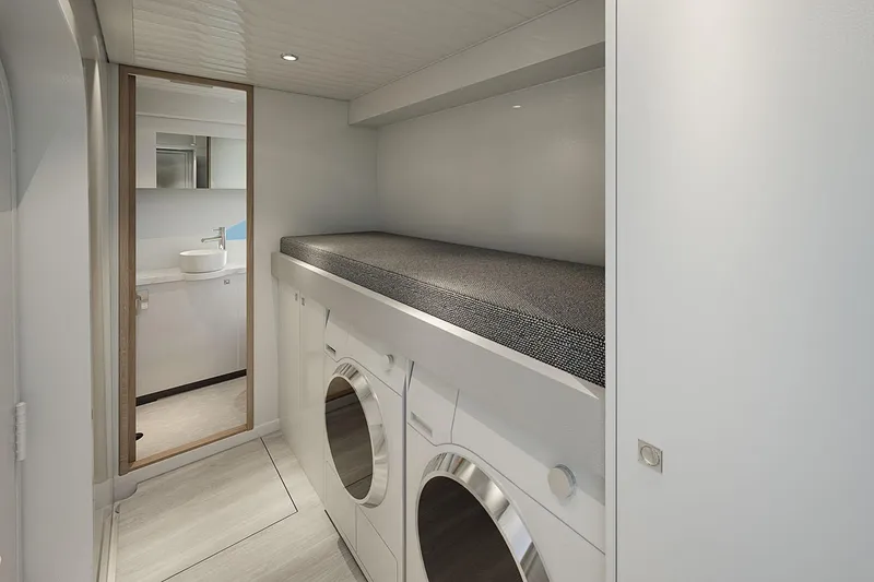 Slide: The Image of Manufacturer Provided Image: Laundry area in 2025 Riviera 585 SUV yacht with washer, dryer, and storage. - 24