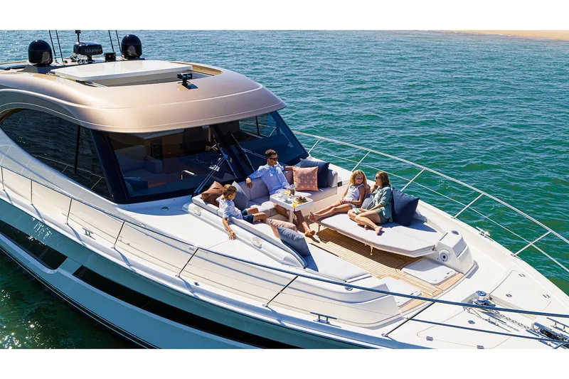 Slide: The Image of Manufacturer Provided Image: 2025 Riviera 585 SUV yacht with people relaxing on deck, cruising on open water. - 6