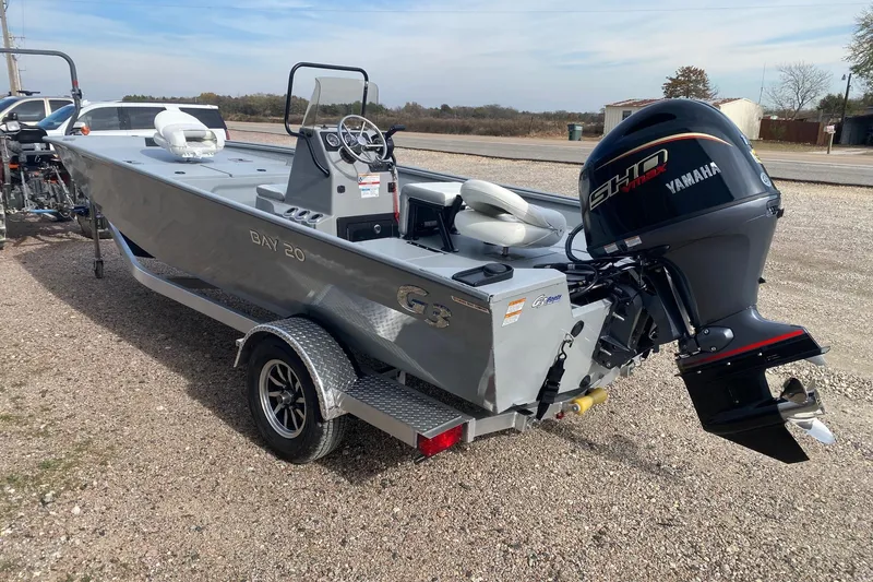 Slide: The Image of 2026 G3 Bay 20 boat with Yamaha motor on trailer, parked outdoors. - 4