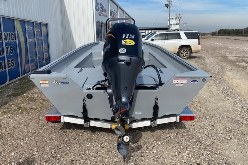 Slide: The Image of 2026 G3 Bay 20 boat on trailer with outboard motor, parked outside dealership. - 6