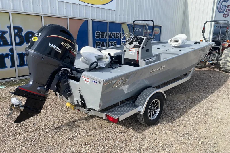 Slide: The Image of 2026 G3 Bay 20 boat with Yamaha engine on a trailer, parked outside a service center. - 7
