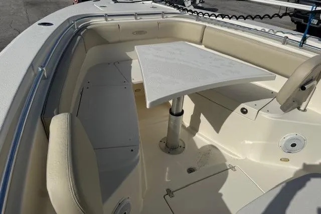 Slide: The Image of 2016 Cobia 277 Center Console boat interior with seating and table. - 7