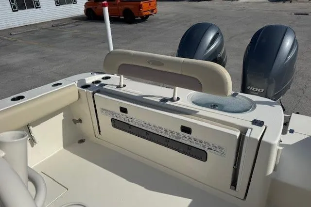 Slide: The Image of 2016 Cobia 277 Center Console boat with dual engines and spacious deck layout. - 9