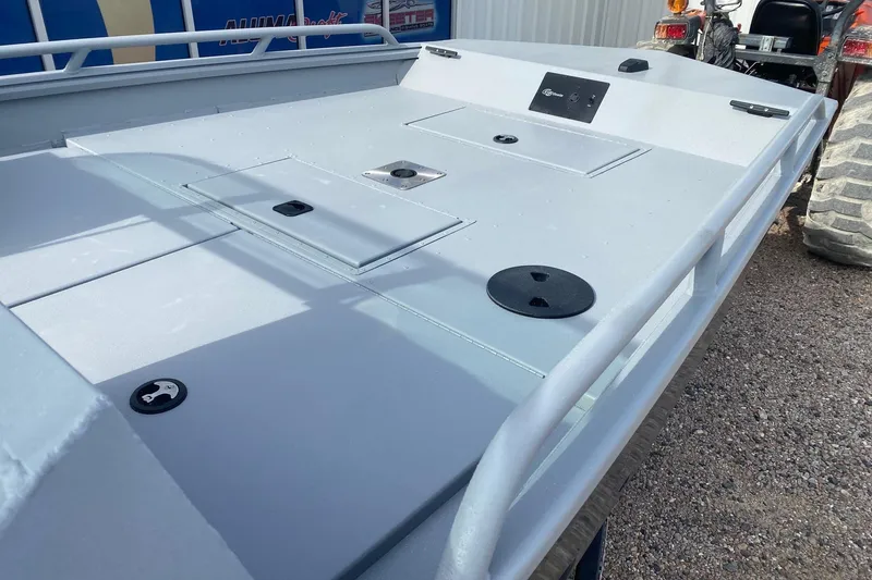 Slide: The Image of 2026 G3 Sportsman 2400 boat deck with storage compartments and railing. - 10