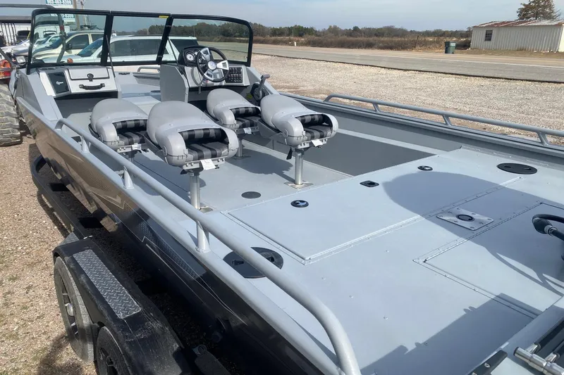 Slide: The Image of 2026 G3 Sportsman 2400 boat with multiple seats and steering console, parked on a trailer. - 11