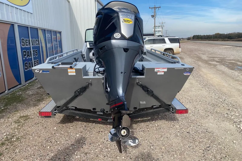Slide: The Image of 2026 G3 Sportsman 2400 boat with outboard motor, parked near service center. - 5