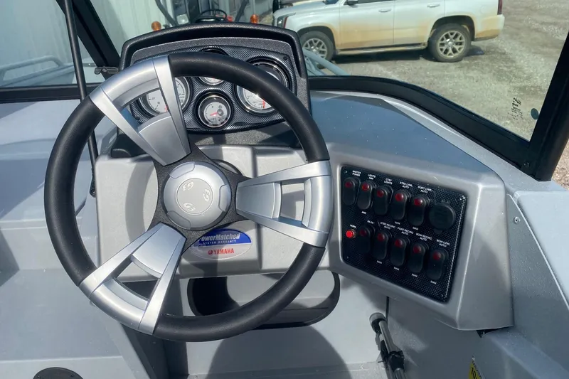 Slide: The Image of Steering wheel and dashboard of 2026 G3 Sportsman 2400 boat, featuring control panel and gauges. - 9