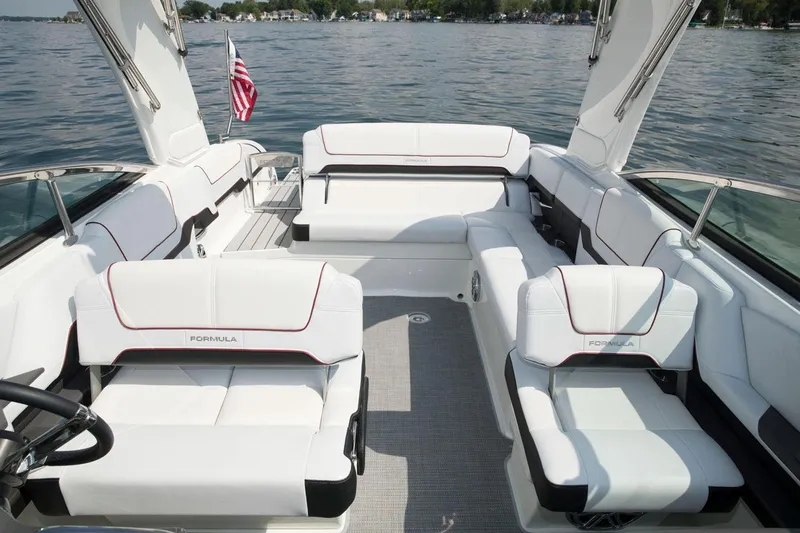 Slide: The Image of Manufacturer Provided Image: 2021 Formula 290 Bowrider boat interior with white seating on a lake. - 12