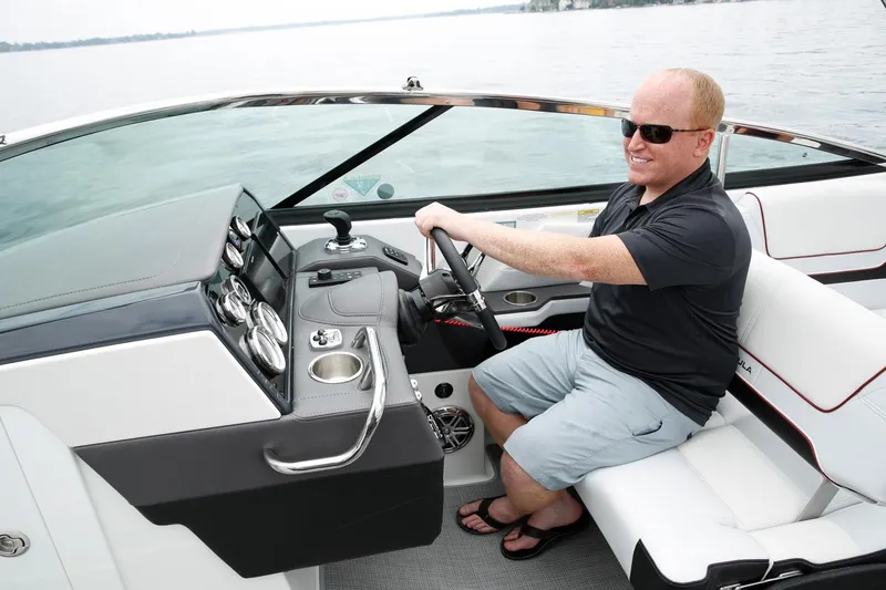 Slide: The Image of Manufacturer Provided Image: Man driving a 2021 Formula 290 Bowrider boat on a calm lake. - 6