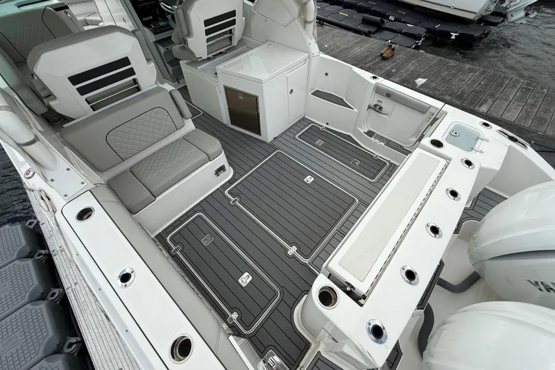 Slide: The Image of 2023 Pursuit DC 326 Dual Console boat interior with sleek seating and modern design. - 11