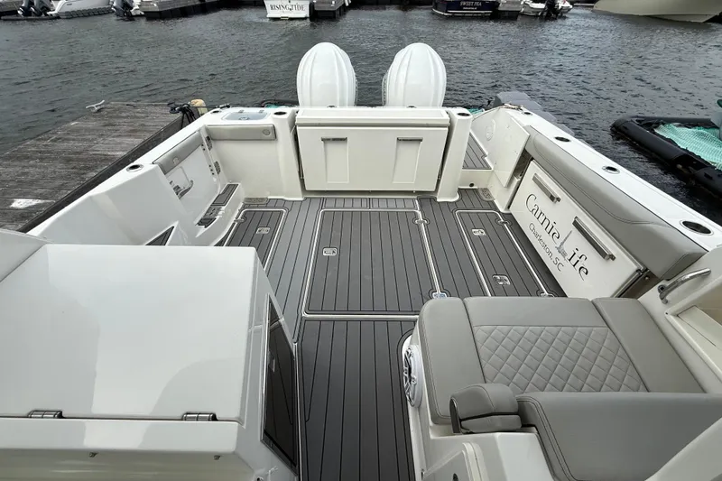 Slide: The Image of 2023 Pursuit DC 326 Dual Console boat interior with sleek seating and modern design. - 12