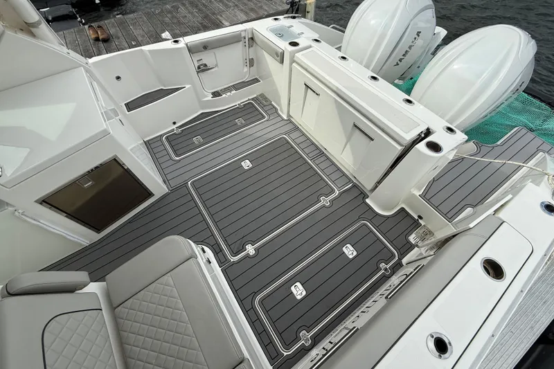 Slide: The Image of 2023 Pursuit DC 326 Dual Console boat interior with sleek seating and Yamaha engines. - 13