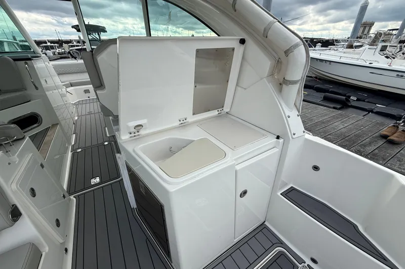 Slide: The Image of 2023 Pursuit DC 326 Dual Console boat interior with sleek design and modern amenities. - 16