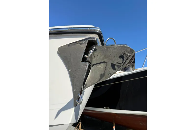 Slide: The Image of 2023 Pursuit DC 326 Dual Console boat anchor detail against clear blue sky. - 35