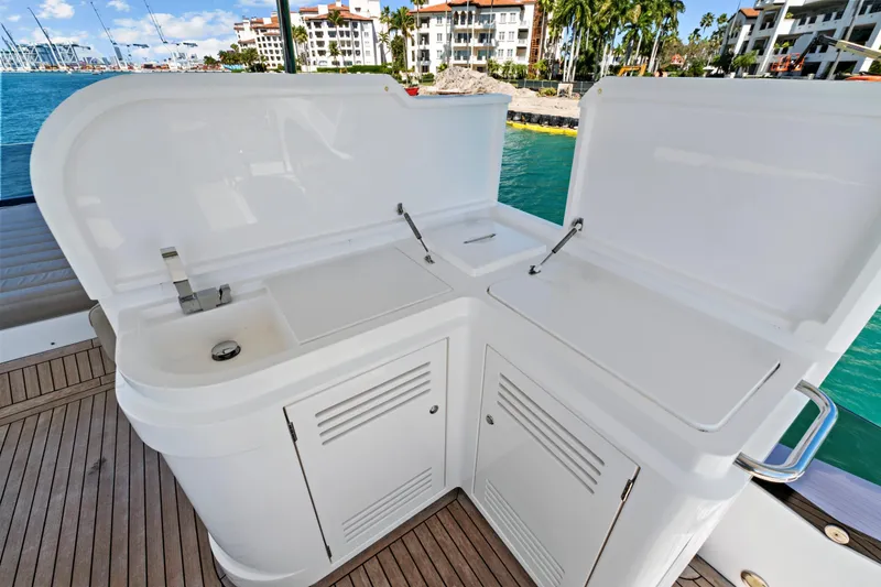 Slide: The Image of Luxury yacht Sunseeker Manhattan 66, 2019 model, featuring a sleek outdoor kitchenette. - 15