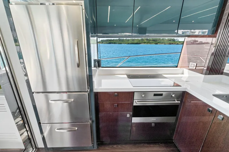 Slide: The Image of Luxurious kitchen on 2019 Sunseeker Manhattan 66 yacht with modern appliances and scenic ocean view. - 21