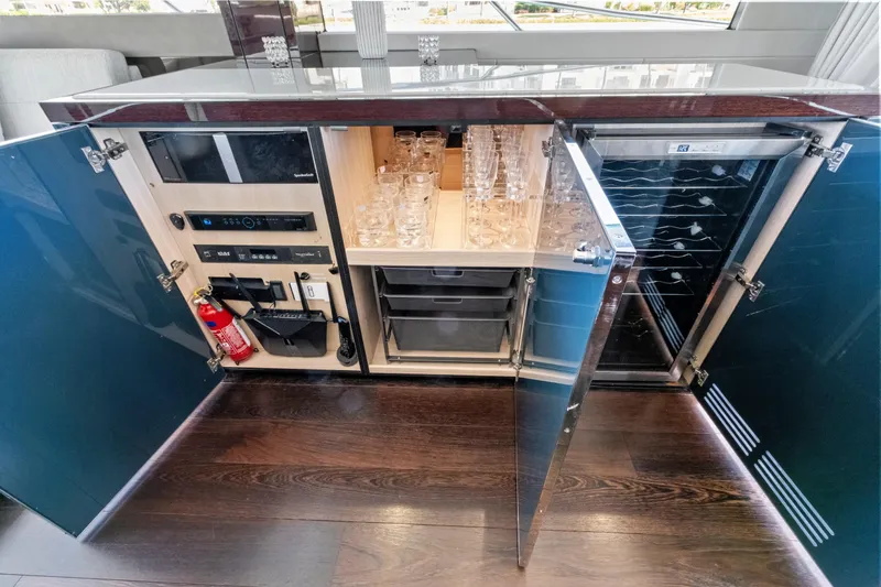 Slide: The Image of Luxurious Sunseeker Manhattan 66 yacht interior bar with glassware and wine storage, 2019 model. - 22