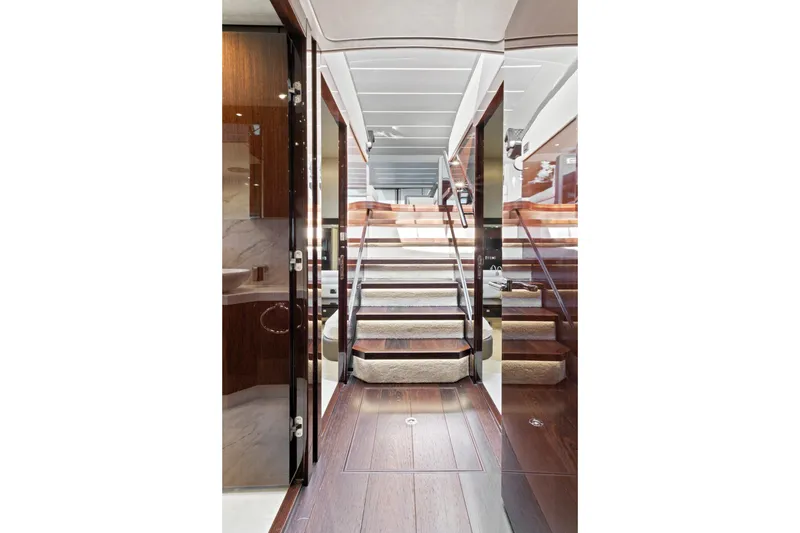 Slide: The Image of Interior of 2019 Sunseeker Manhattan 66 yacht, featuring elegant wooden stairs and modern design. - 30