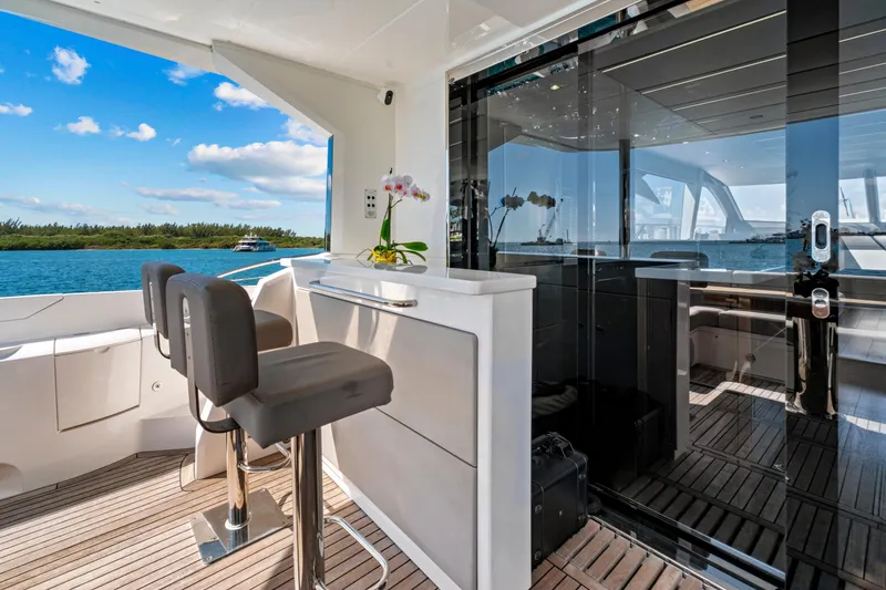 Slide: The Image of Luxurious 2019 Sunseeker Manhattan 66 yacht interior with bar stools and ocean view. - 8