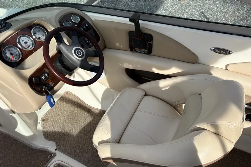 Slide: The Image of Interior of a 2007 Chaparral 190 SSi boat, featuring steering wheel and gauges. - 12