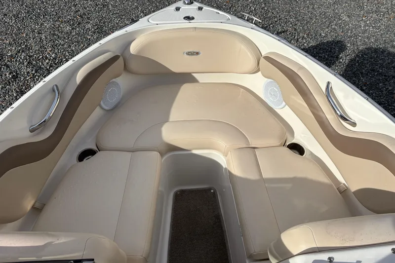 Slide: The Image of 2007 Chaparral 190 SSi boat interior with beige seating and stainless steel accents. - 5