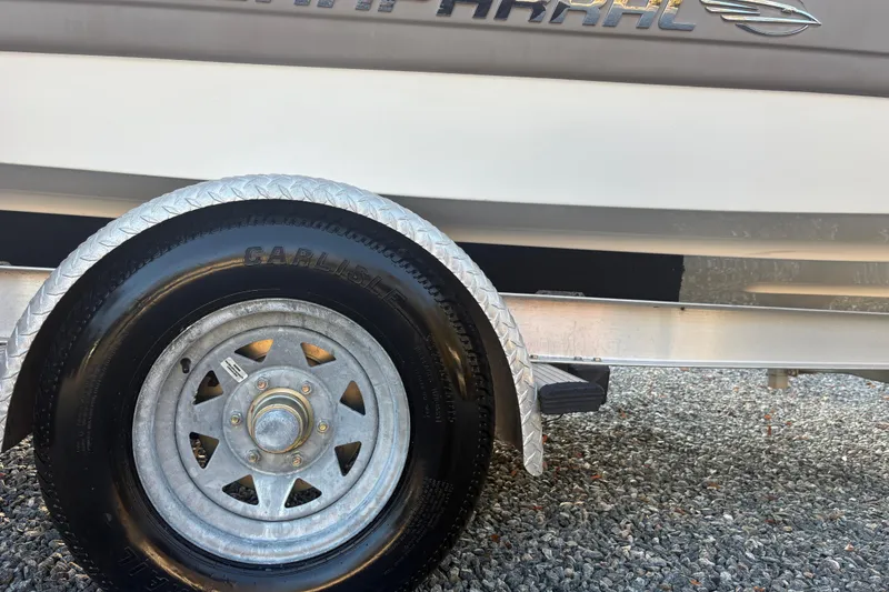 Slide: The Image of Trailer wheel of 2007 Chaparral 190 SSi boat on gravel surface. - 6