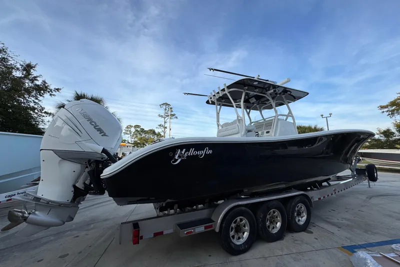 Slide: The Image of 2019 Yellowfin 34 Offshore boat on trailer, featuring Mercury outboard engines. - 10
