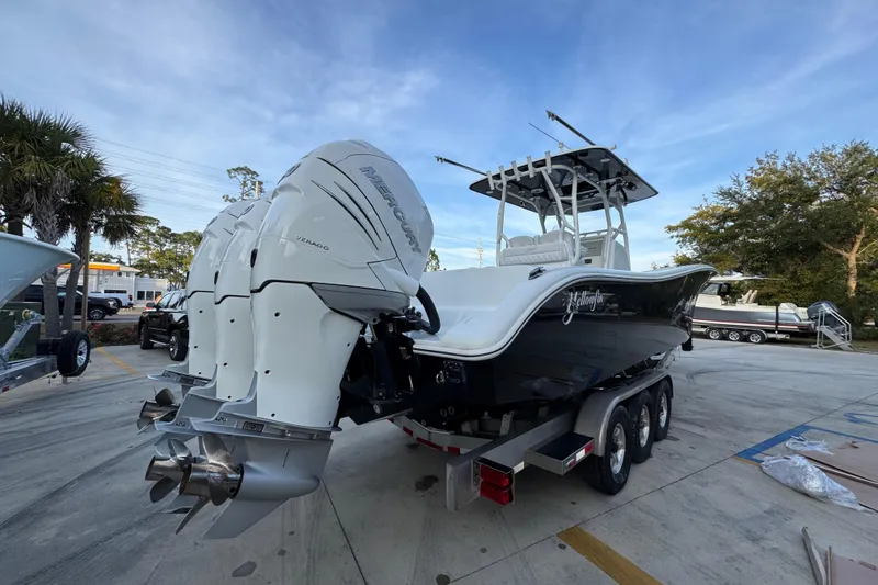 Slide: The Image of 2019 Yellowfin 34 Offshore boat with triple Mercury engines on a trailer. - 11
