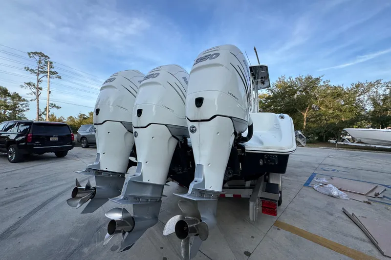 Slide: The Image of 2019 Yellowfin 34 Offshore boat with triple outboard engines on a trailer. - 12