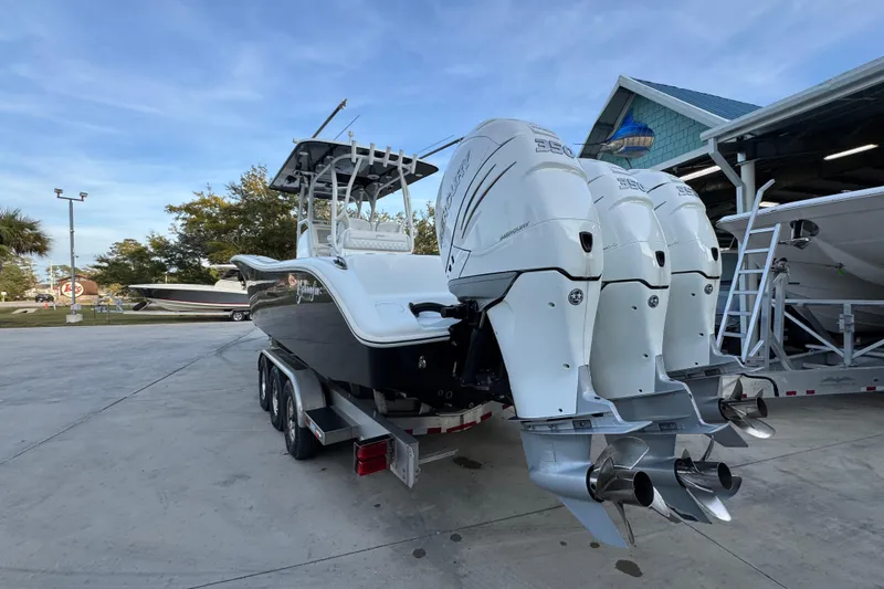 Slide: The Image of 2019 Yellowfin 34 Offshore boat with triple outboard engines on a trailer. - 14