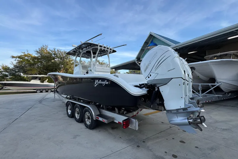 Slide: The Image of 2019 Yellowfin 34 Offshore boat on trailer, featuring powerful Mercury outboard engines. - 15