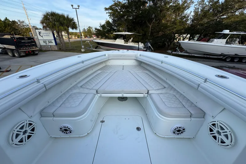 Slide: The Image of 2019 Yellowfin 34 Offshore boat interior with cushioned seating and speakers. - 18