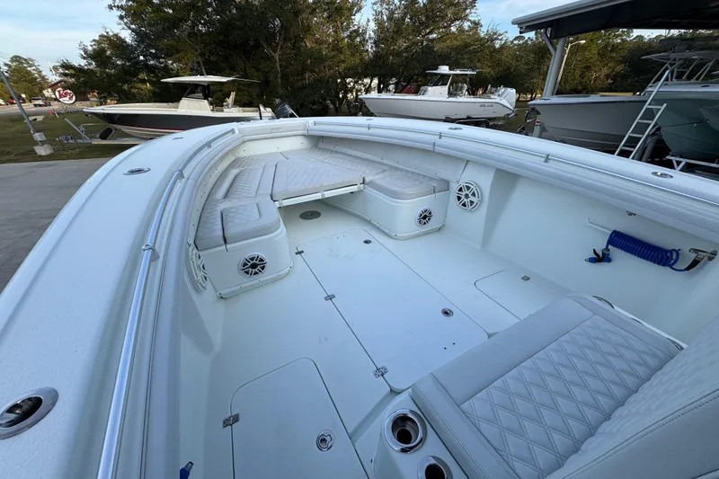 Slide: The Image of 2019 Yellowfin 34 Offshore boat interior with cushioned seating and speakers. - 19