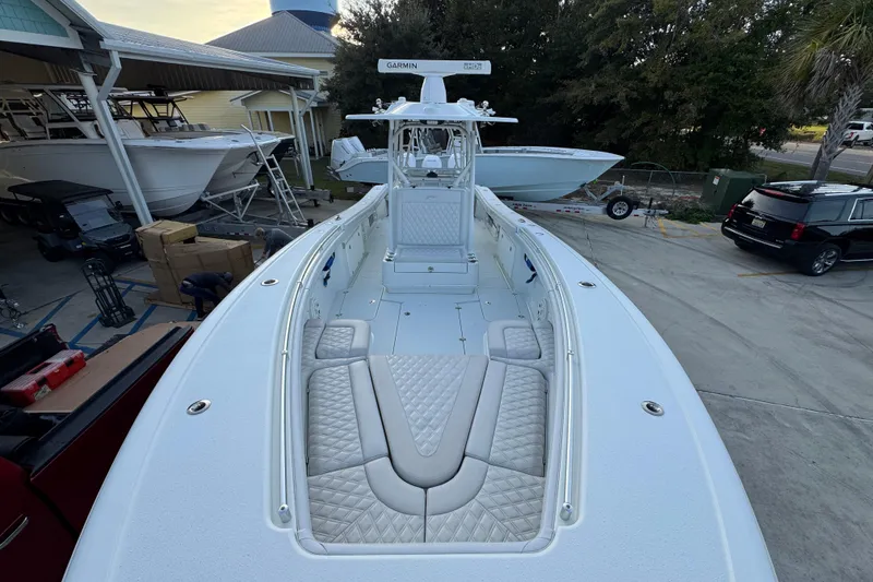 Slide: The Image of 2019 Yellowfin 34 Offshore boat with spacious deck and seating, docked at a marina. - 21