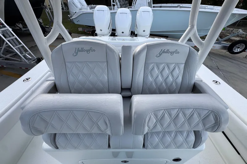 Slide: The Image of 2019 Yellowfin 34 Offshore boat with luxurious diamond-stitched seats and dual outboard motors. - 26