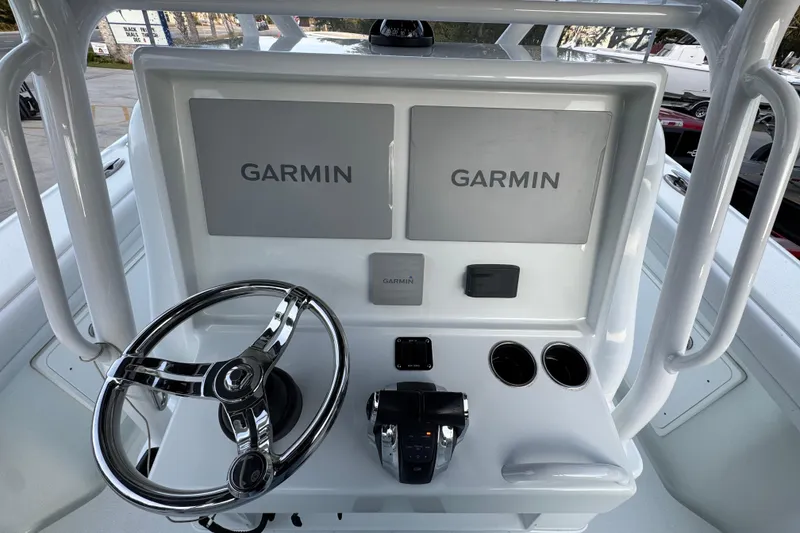 Slide: The Image of 2019 Yellowfin 34 Offshore boat console with dual Garmin displays and steering wheel. - 29