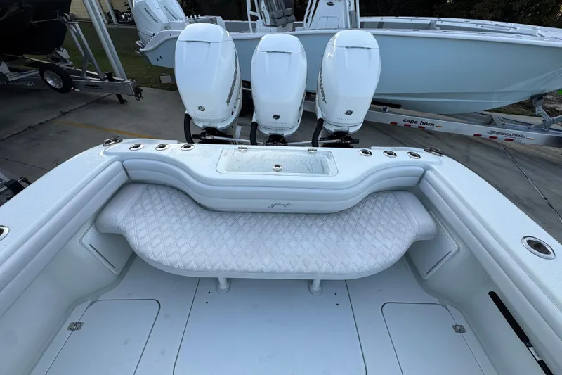 Slide: The Image of 2019 Yellowfin 34 Offshore boat with triple outboard engines and cushioned seating. - 38