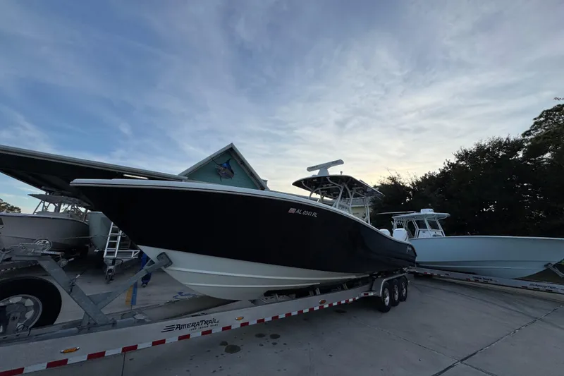Slide: The Image of 2019 Yellowfin 34 Offshore boat on trailer, parked outdoors under a clear sky. - 4
